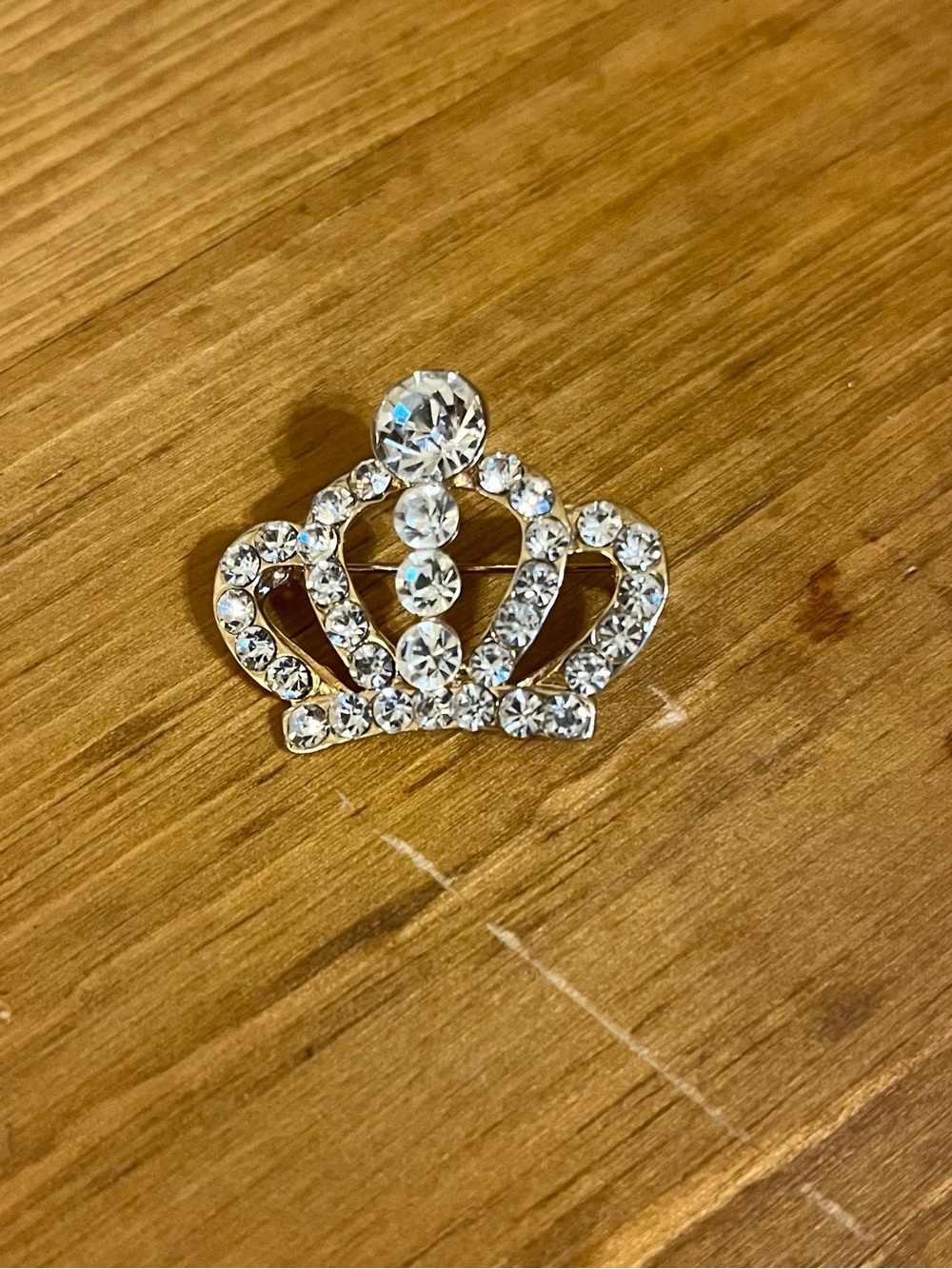 Rhinestone princess crown brooch on gold tone backing & roll over clasp 1” down